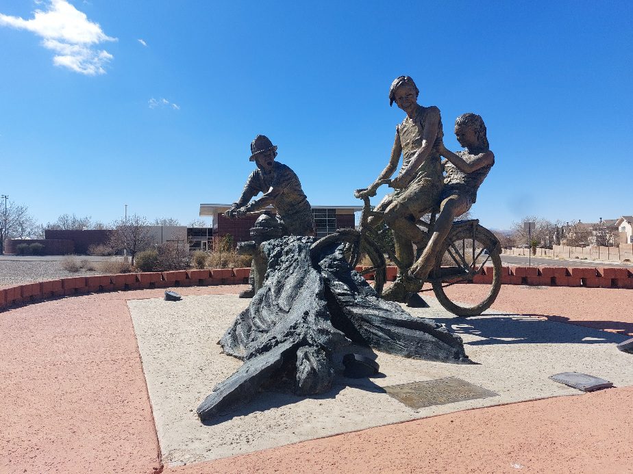 Reynaldo Rivera's bronze sculpture 'A Cool Friend' depicts a bicyclist with a rider on the back riding through water flowing from a fire hydrant.