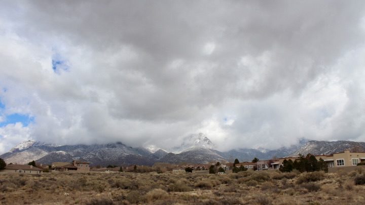 Fog and Clouds over snow frosted Sandia Mountains