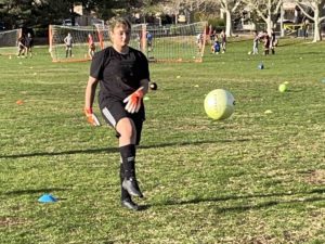 Gabriela kicking ball