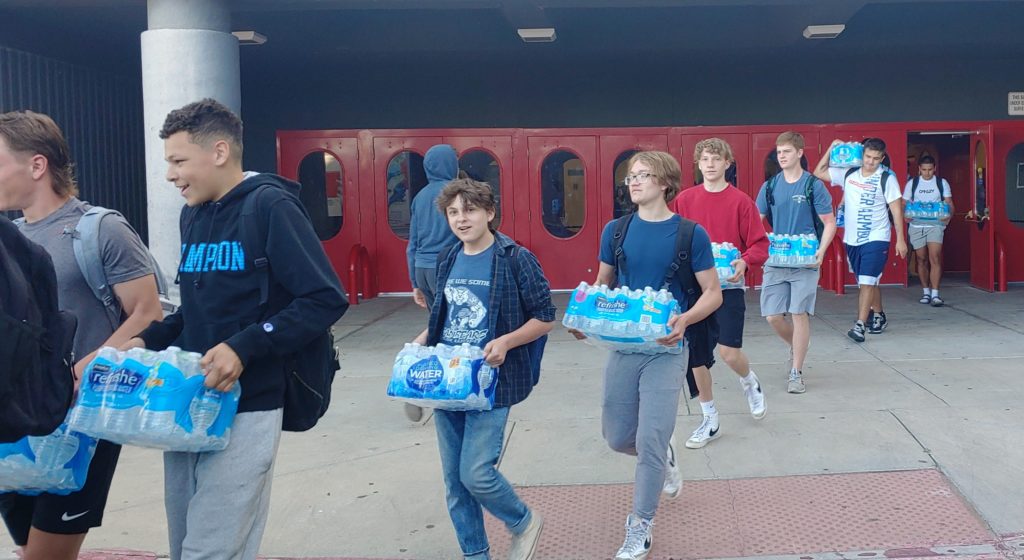 La Cueva cheer, football teams lend a helping hand to fire victims