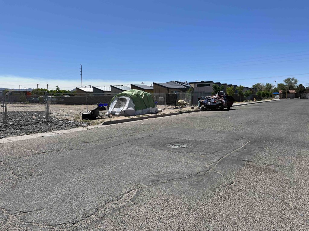 A tent and car next to the Tiny Home Village